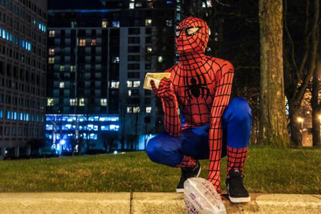 Spiderman feeds homeless at night